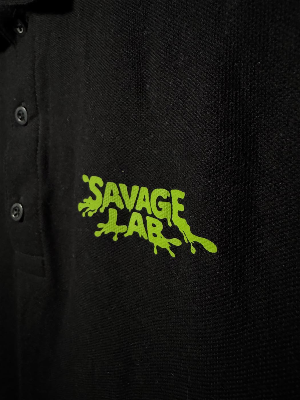 Printed logo on a black polo shirt